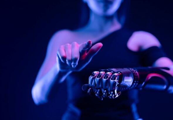 Close-up of a robotic hand with a woman pointing, showcasing advanced prosthetic technology.