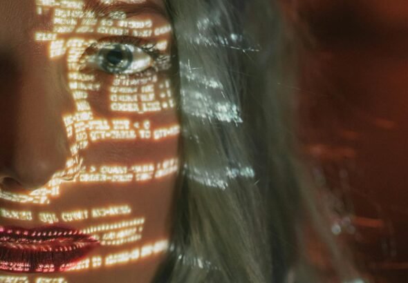 Abstract cyberpunk portrait with code projected on a woman's half face, symbolizing technology integration.