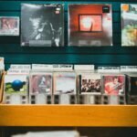 A nostalgic music store display featuring vinyl records and CDs on wooden shelves.