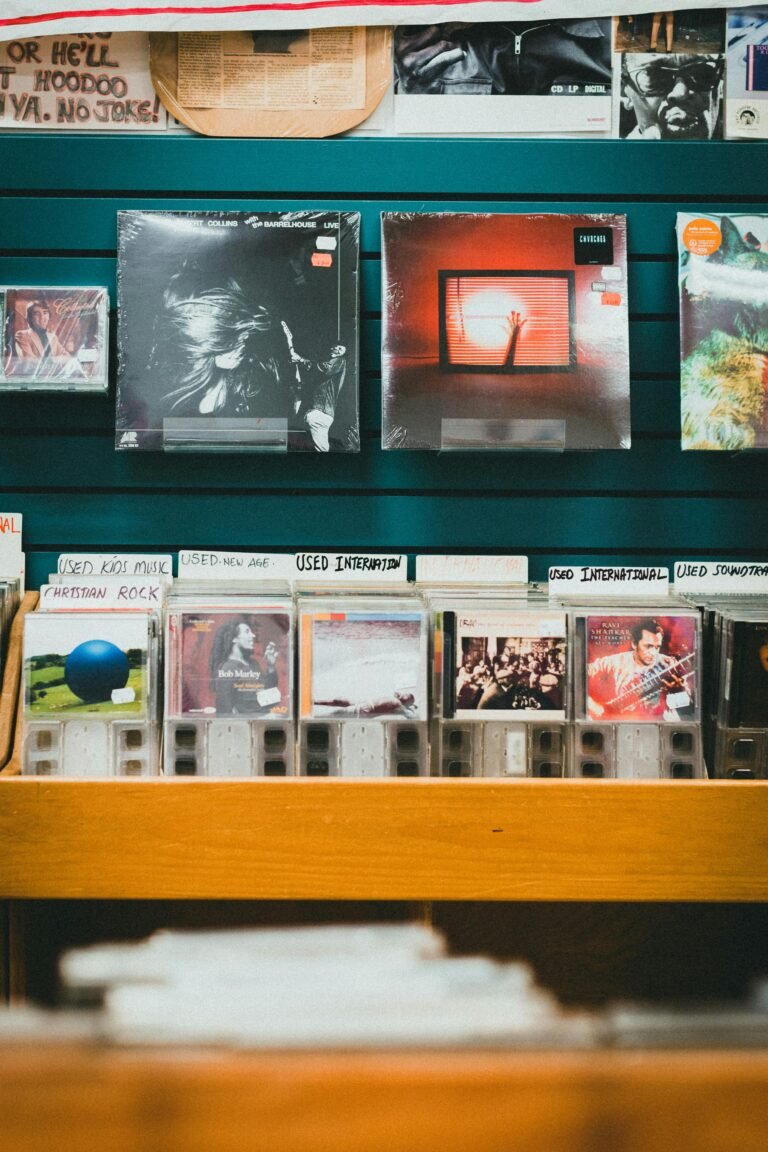 A nostalgic music store display featuring vinyl records and CDs on wooden shelves.